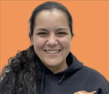 woman in front of orange wall