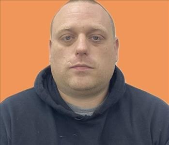 man in front of orange background